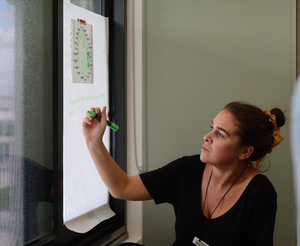Teacher planning on paper against a window
